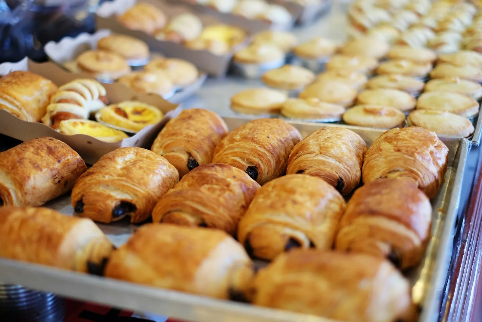 Trays of fresh chocolate croissants and pastries