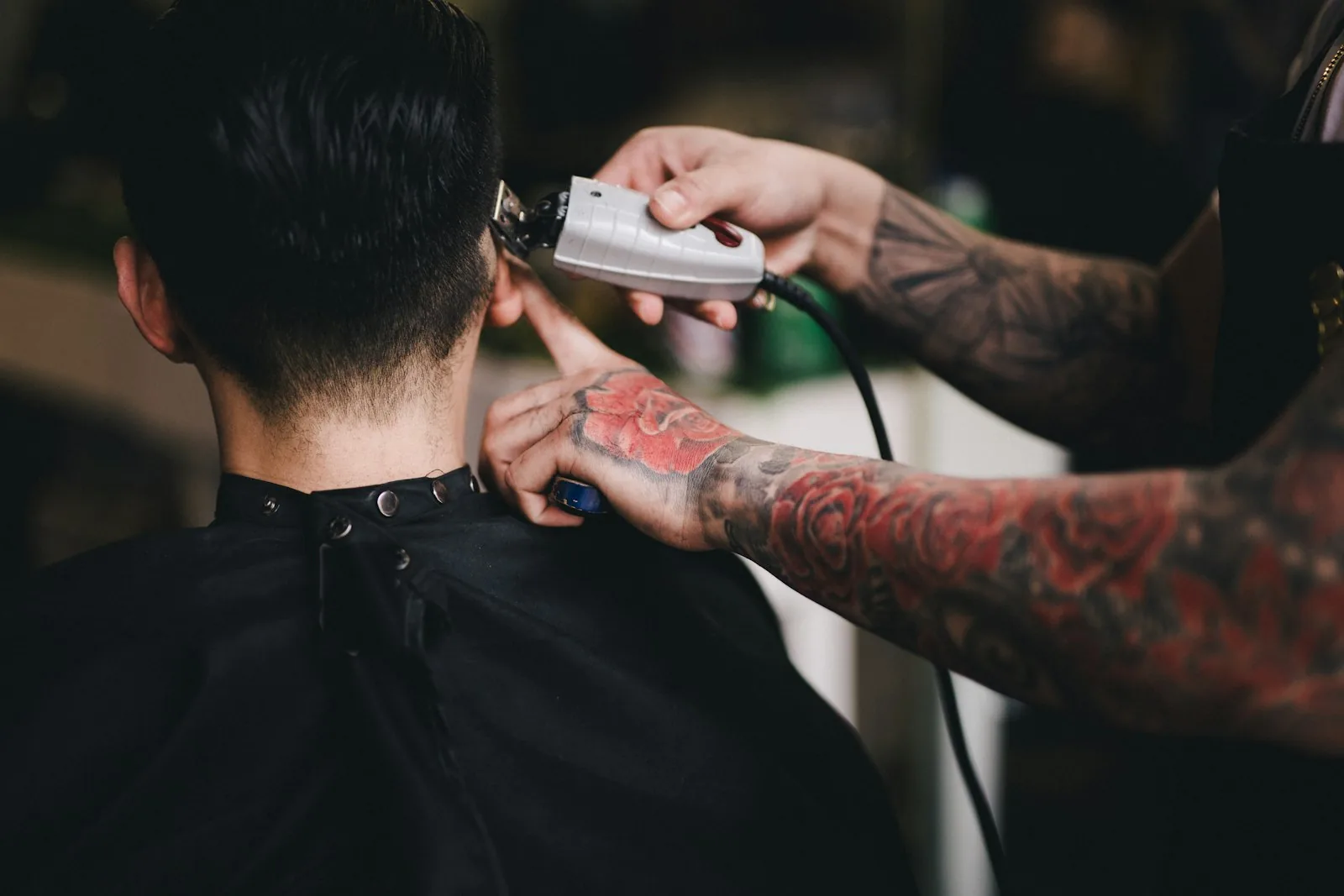 Barber trimming a client's neckline with clippers